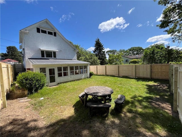16 Winthrop St, Cranston, RI 02910 - rear view of property featuring a sunroom and a fenced backyard