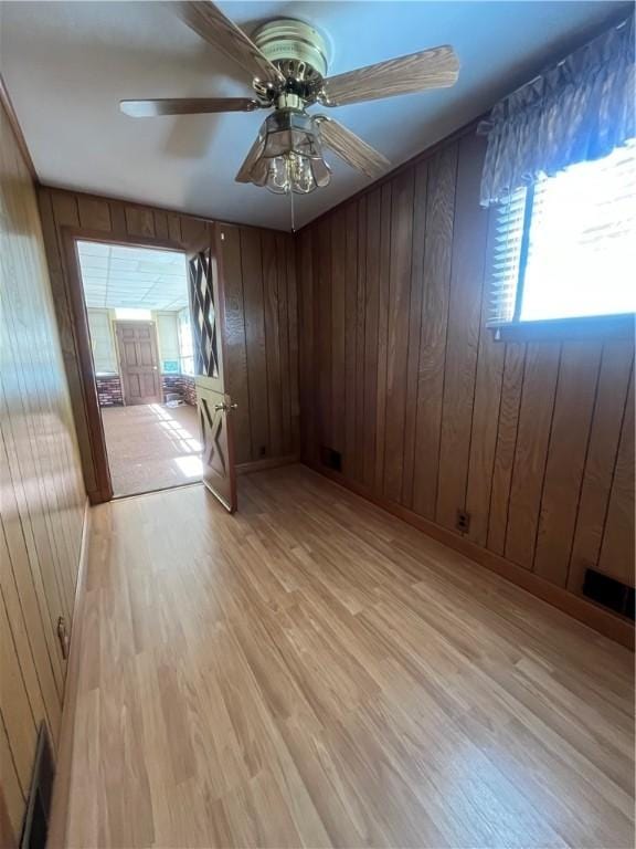 16 Winthrop St, Cranston, RI 02910 - unfurnished room featuring light wood-type flooring, healthy amount of natural light, ceiling fan, and wood walls