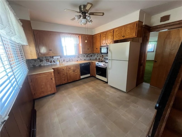 16 Winthrop St, Cranston, RI 02910 - kitchen with black appliances, decorative backsplash, ceiling fan, light countertops, and light flooring