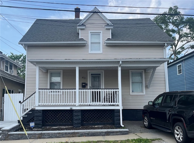 43 Toronto Ave, Providence, RI 02905 - view of front of home featuring a porch, a shingled roof, and a chimney