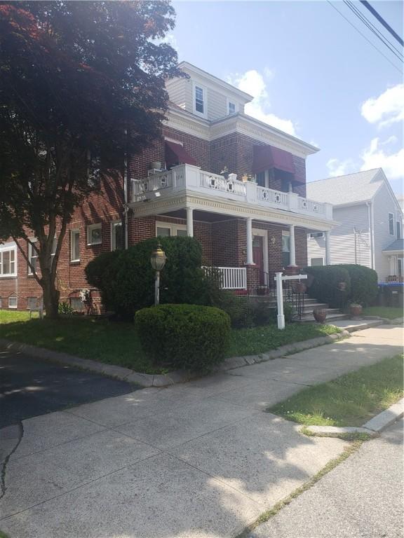 106 Langdon St, Providence, RI 02904 - view of front facade featuring brick siding and a balcony