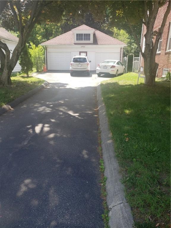 106 Langdon St, Providence, RI 02904 - view of front of home with a garage and a front lawn