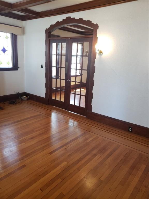 106 Langdon St, Providence, RI 02904 - spare room featuring french doors, hardwood / wood-style floors, and beam ceiling