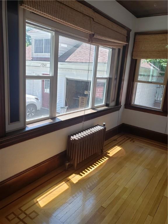 106 Langdon St, Providence, RI 02904 - unfurnished room featuring radiator and wood-type flooring