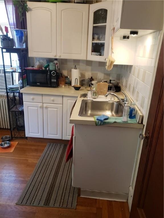 106 Langdon St, Providence, RI 02904 - kitchen with black microwave, dark wood-type flooring, white cabinets, glass insert cabinets, and light countertops