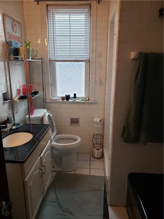106 Langdon St, Providence, RI 02904 - bathroom with tile walls, tile patterned floors, vanity, a shower, and a bathtub