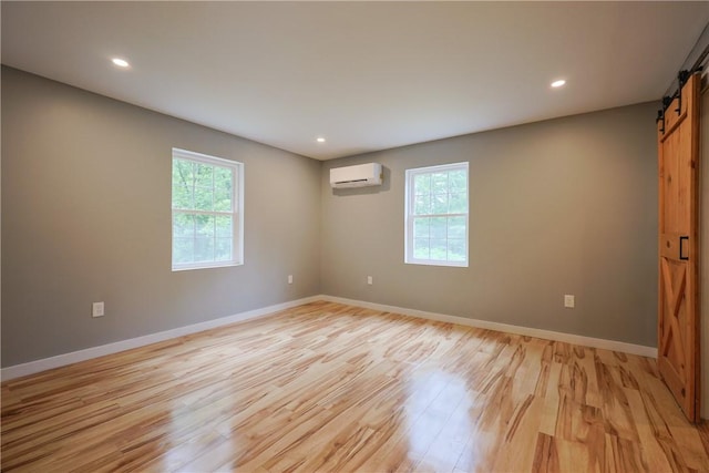 154 Foster Center Rd, Foster, RI 02825 - spare room with a barn door, plenty of natural light, light wood finished floors, a wall mounted air conditioner, and recessed lighting