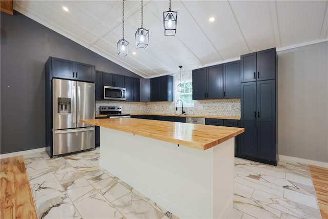 154 Foster Center Rd, Foster, RI 02825 - kitchen with appliances with stainless steel finishes, butcher block countertops, lofted ceiling, light marble finish flooring, and decorative light fixtures