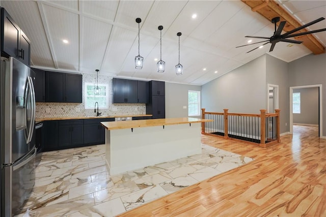 154 Foster Center Rd, Foster, RI 02825 - kitchen with stainless steel fridge with ice dispenser, butcher block countertops, decorative backsplash, a kitchen island, and a ceiling fan