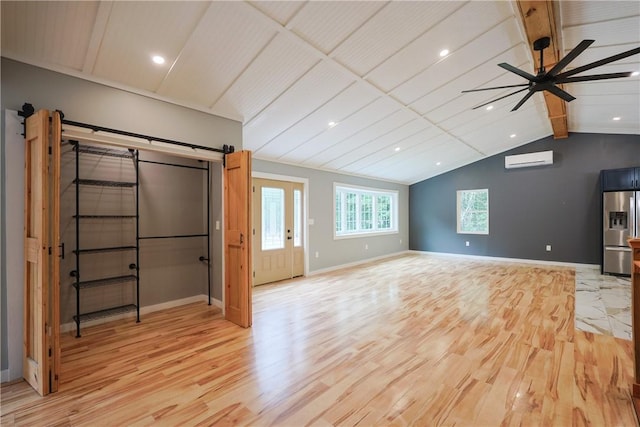 154 Foster Center Rd, Foster, RI 02825 - unfurnished living room with a wall unit AC, light wood-style flooring, ceiling fan, a barn door, and recessed lighting