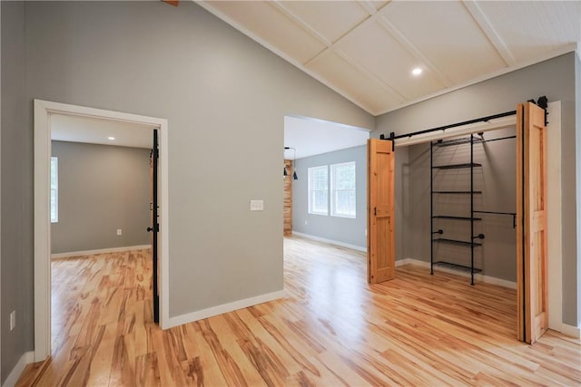154 Foster Center Rd, Foster, RI 02825 - interior space with light wood-style floors, beamed ceiling, recessed lighting, high vaulted ceiling, and a barn door