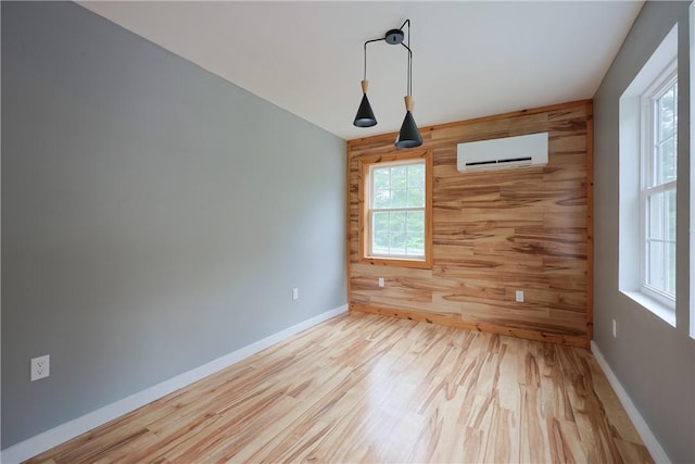 154 Foster Center Rd, Foster, RI 02825 - empty room with an AC wall unit, wooden walls, and wood finished floors