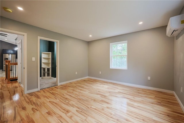 154 Foster Center Rd, Foster, RI 02825 - spare room featuring light wood-style flooring, a wall mounted AC, recessed lighting, and a smoke detector