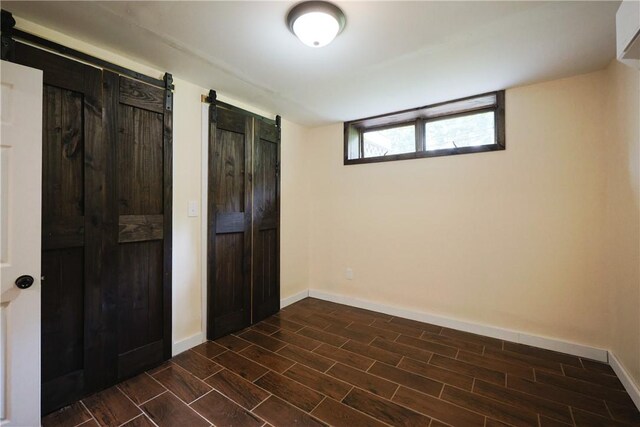 154 Foster Center Rd, Foster, RI 02825 - unfurnished bedroom featuring wood tiled floors and two closets