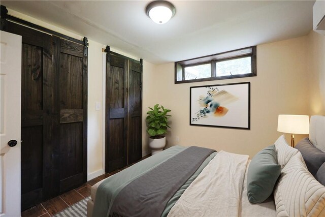 154 Foster Center Rd, Foster, RI 02825 - bedroom with dark wood-style flooring, two closets, and a barn door