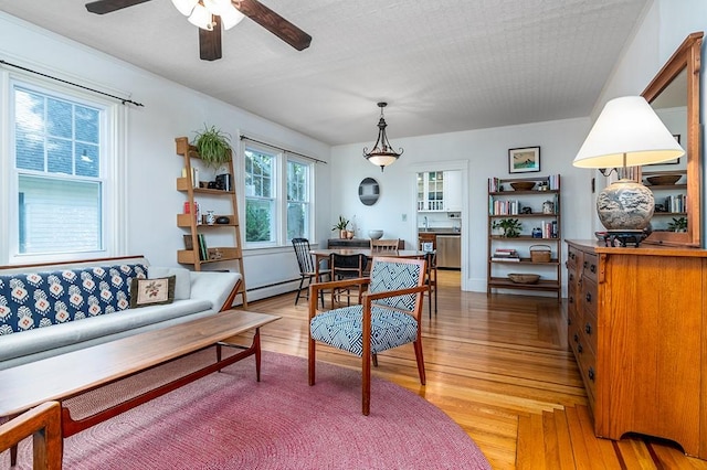 25 Sheffield Ave, North Providence, RI 02911 - living room with a ceiling fan, light wood finished floors, and baseboard heating