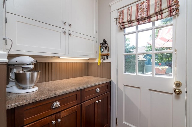 25 Sheffield Ave, North Providence, RI 02911 - kitchen with white cabinets, light stone countertops, and wooden walls