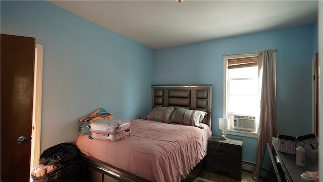 271 Union Ave, Providence, RI 02909 - bedroom with a baseboard radiator, cooling unit, and wood finished floors