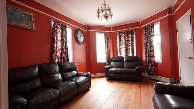 271 Union Ave, Providence, RI 02909 - living area featuring baseboard heating, light wood finished floors, a chandelier, and ornamental molding