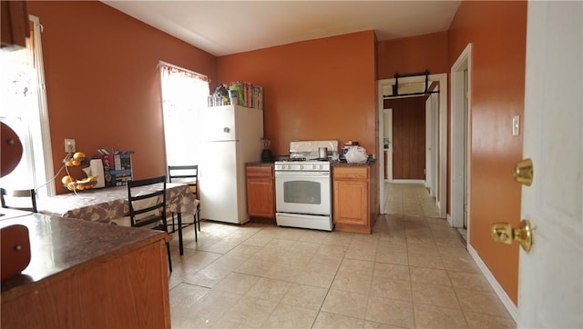 271 Union Ave, Providence, RI 02909 - kitchen with white appliances, dark countertops, and light tile patterned flooring