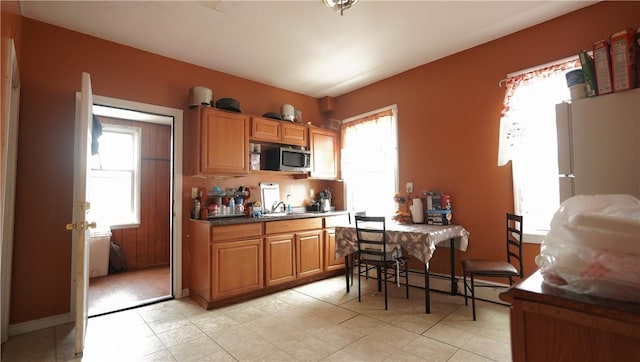 271 Union Ave, Providence, RI 02909 - kitchen featuring stainless steel microwave, brown cabinetry, and light floors