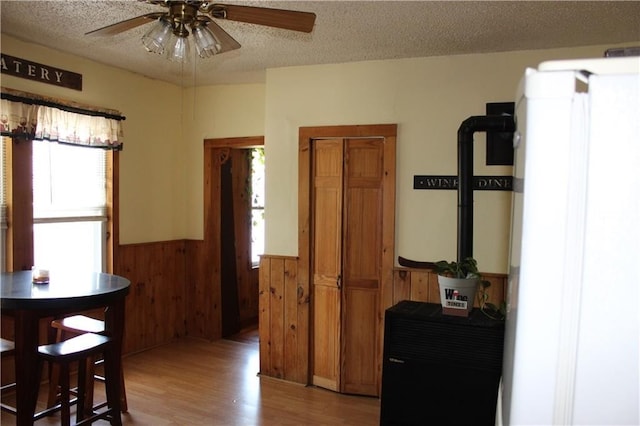 494 Grove St, Woonsocket, RI 02895 - kitchen featuring wainscoting, ceiling fan, wood finished floors, a textured ceiling, and wooden walls