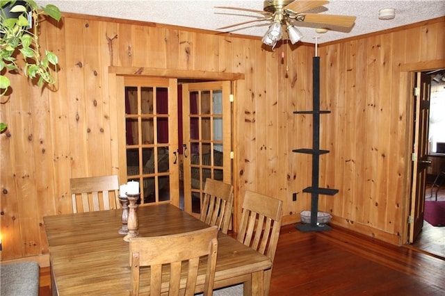 494 Grove St, Woonsocket, RI 02895 - unfurnished dining area featuring wooden walls, a ceiling fan, ornamental molding, french doors, and wood-type flooring
