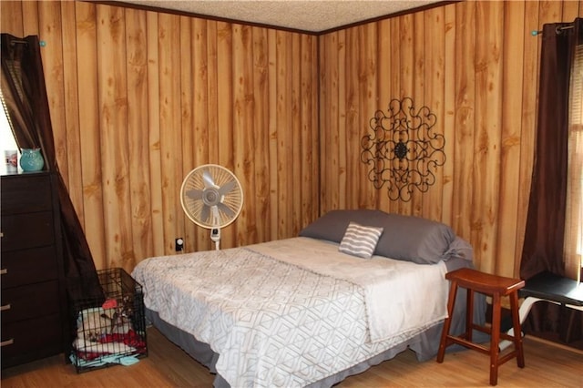 494 Grove St, Woonsocket, RI 02895 - bedroom with wooden walls, a textured ceiling, and wood finished floors