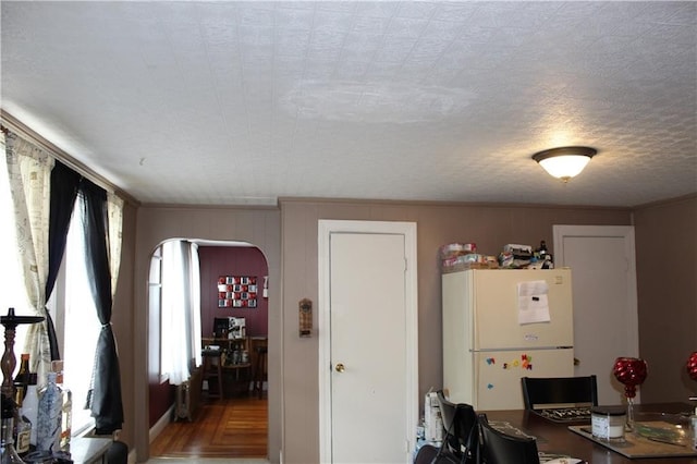 494 Grove St, Woonsocket, RI 02895 - dining space with arched walkways, ornamental molding, and light wood-type flooring