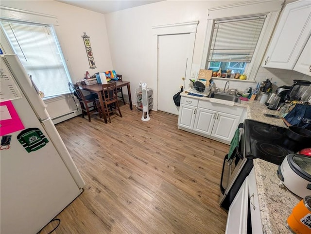 10 Stamford Ave, Providence, RI 02907 - kitchen with range with electric cooktop, light wood-style flooring, white cabinetry, backsplash, and light stone counters