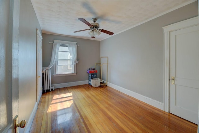 58 Cliffdale Ave, Cranston, RI 02905 - spare room featuring hardwood / wood-style floors, a ceiling fan, ornamental molding, and radiator