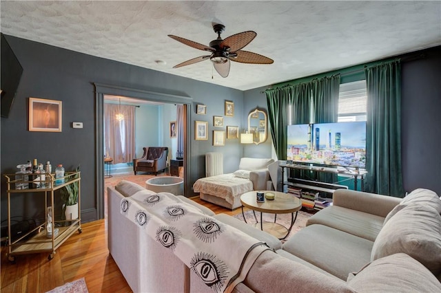58 Cliffdale Ave, Cranston, RI 02905 - living area with radiator heating unit, wood finished floors, a ceiling fan, and a textured ceiling