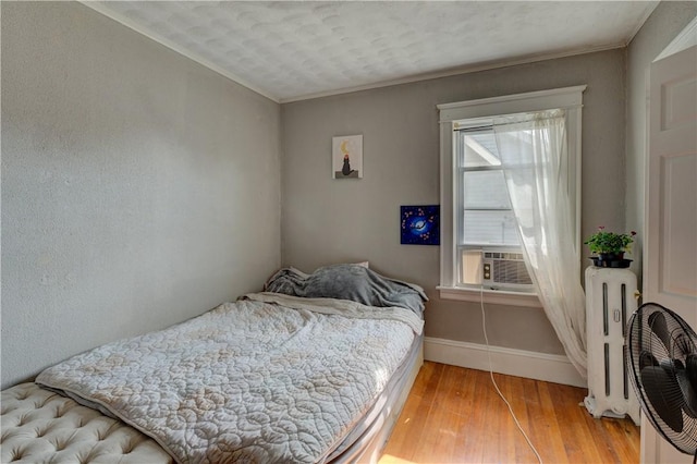58 Cliffdale Ave, Cranston, RI 02905 - bedroom featuring radiator heating unit, light wood-style flooring, cooling unit, and ornamental molding