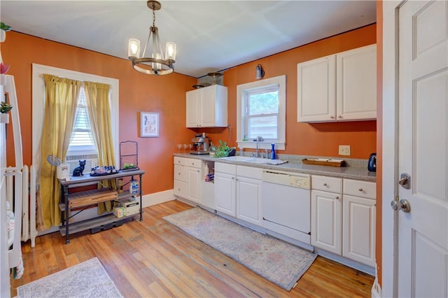 58 Cliffdale Ave, Cranston, RI 02905 - kitchen with white dishwasher, a chandelier, light wood-style floors, and white cabinets