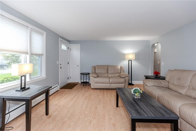 40 Lufkin Ct, Warwick, RI 02888 - living room with a baseboard heating unit, arched walkways, and light wood-type flooring