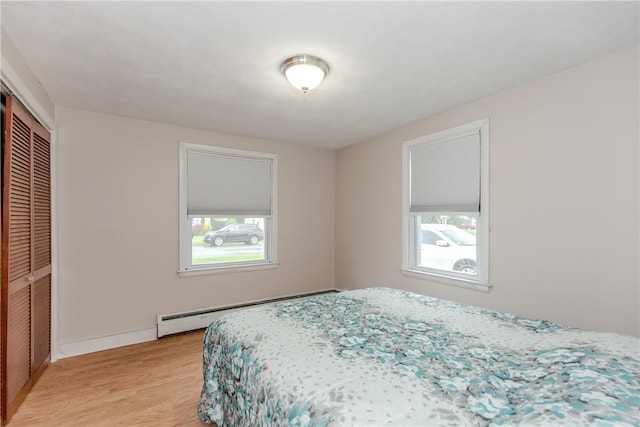 40 Lufkin Ct, Warwick, RI 02888 - bedroom with baseboard heating, light wood-style floors, and a closet