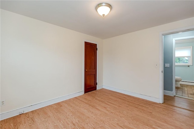 40 Lufkin Ct, Warwick, RI 02888 - empty room with light wood finished floors and baseboard heating