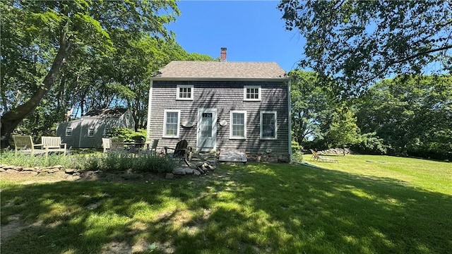 815 Beacon Hill Rd, Block Island, RI 02807 - back of house with a chimney and a lawn