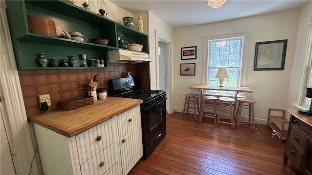 815 Beacon Hill Rd, Block Island, RI 02807 - kitchen with black gas stove, wall chimney exhaust hood, butcher block countertops, dark wood-style floors, and open shelves