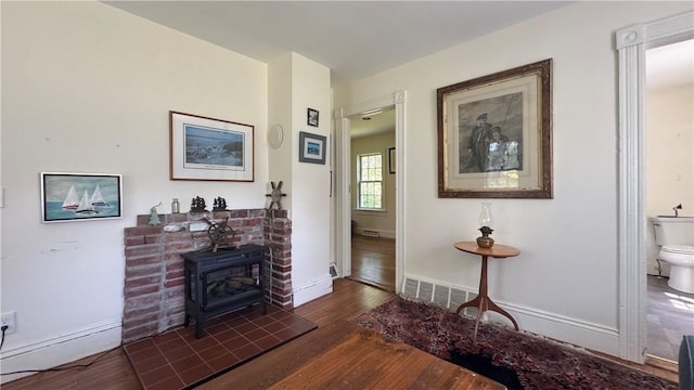 815 Beacon Hill Rd, Block Island, RI 02807 - living room featuring dark wood-type flooring and a wood stove