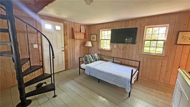 815 Beacon Hill Rd, Block Island, RI 02807 - bedroom with light wood-style floors and wooden walls