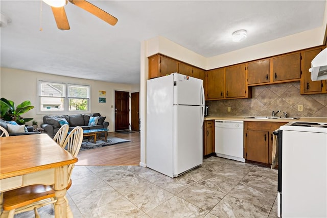 116 Balsam Rd, South Kingstown, RI 02879 - kitchen with white appliances, open floor plan, ceiling fan, brown cabinetry, and light countertops