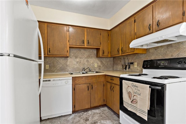 116 Balsam Rd, South Kingstown, RI 02879 - kitchen featuring white appliances, under cabinet range hood, light countertops, tasteful backsplash, and brown cabinetry