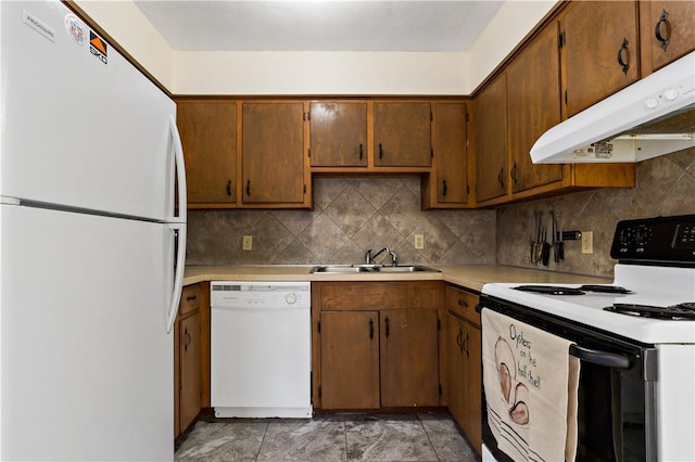 116 Balsam Rd, South Kingstown, RI 02879 - kitchen with white appliances, under cabinet range hood, light countertops, tasteful backsplash, and brown cabinetry