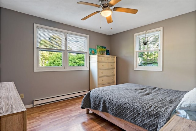 116 Balsam Rd, South Kingstown, RI 02879 - bedroom featuring baseboard heating, wood finished floors, and a ceiling fan