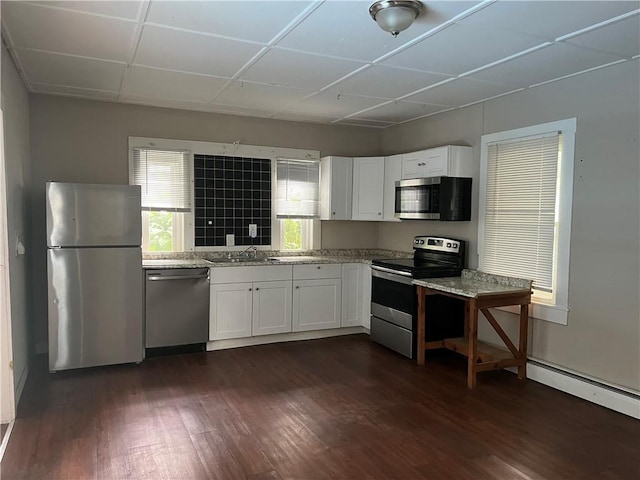 66 Railroad St, South Kingstown, RI 02879 - kitchen featuring appliances with stainless steel finishes, white cabinetry, dark wood-type flooring, light stone countertops, and a baseboard heating unit