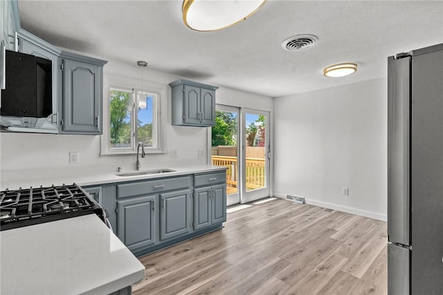 299 George Arden Ave, Warwick, RI 02886 - kitchen featuring freestanding refrigerator, black microwave, light wood finished floors, and light countertops