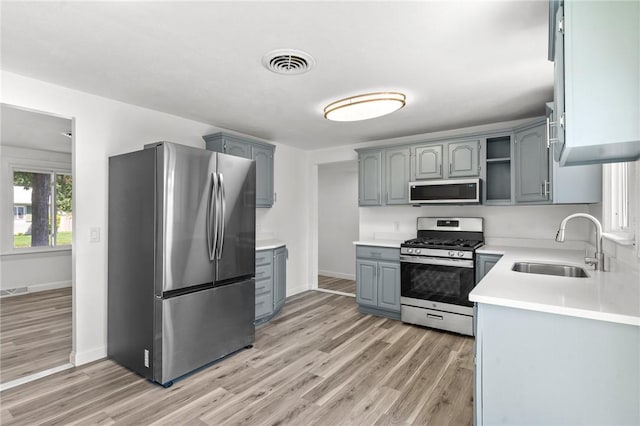 299 George Arden Ave, Warwick, RI 02886 - kitchen with stainless steel appliances, light wood-style flooring, light countertops, and gray cabinetry