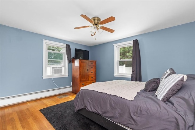 41 Valley View Dr, Cumberland, RI 02864 - bedroom featuring a baseboard heating unit, wood finished floors, ceiling fan, and cooling unit