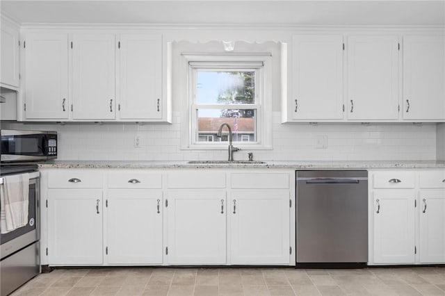 41 Valley View Dr, Cumberland, RI 02864 - kitchen with stainless steel appliances, white cabinetry, tasteful backsplash, and light stone countertops
